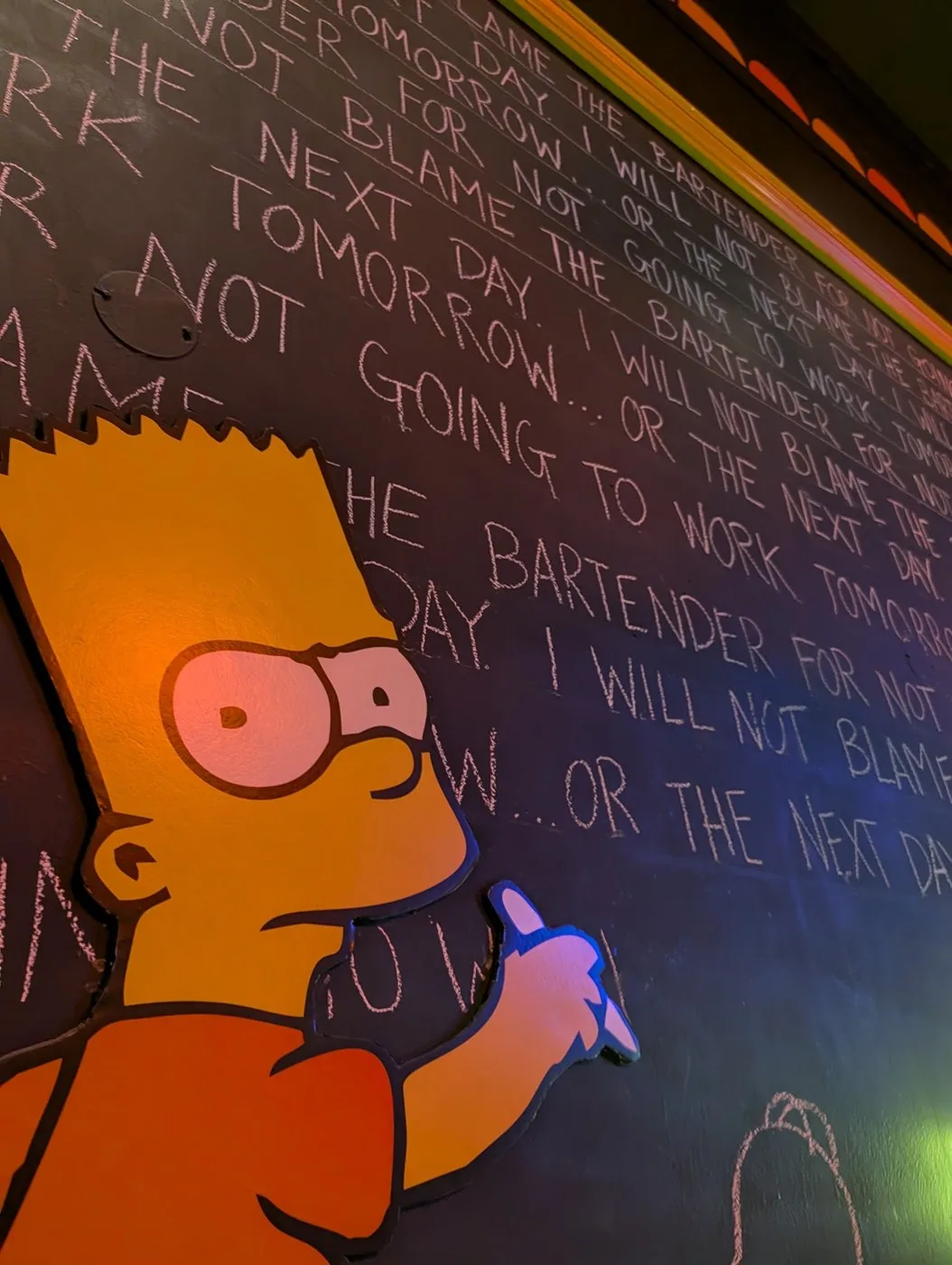 Bart Simpson cutout writing lines on the chalkboard wall at Moez Tavern: I will not blame the bartender for not going to work tomorrow