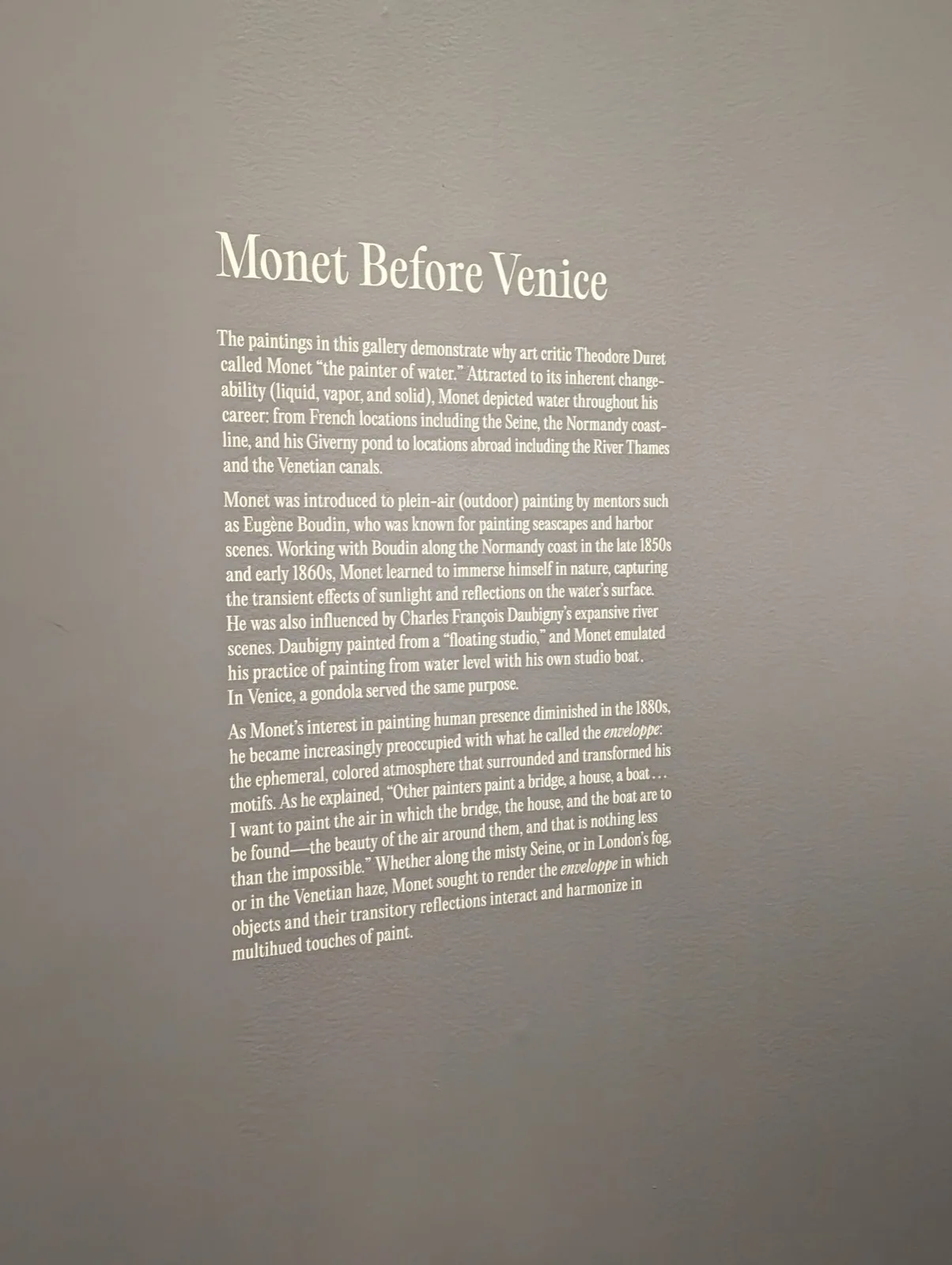 Gallery wall text at the de Young Museum titled Monet Before Venice, describing Monet as the painter of water