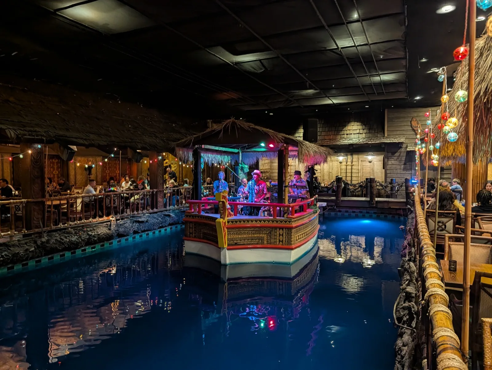 The band performing on the floating barge in the Tonga Room lagoon, strung with lights